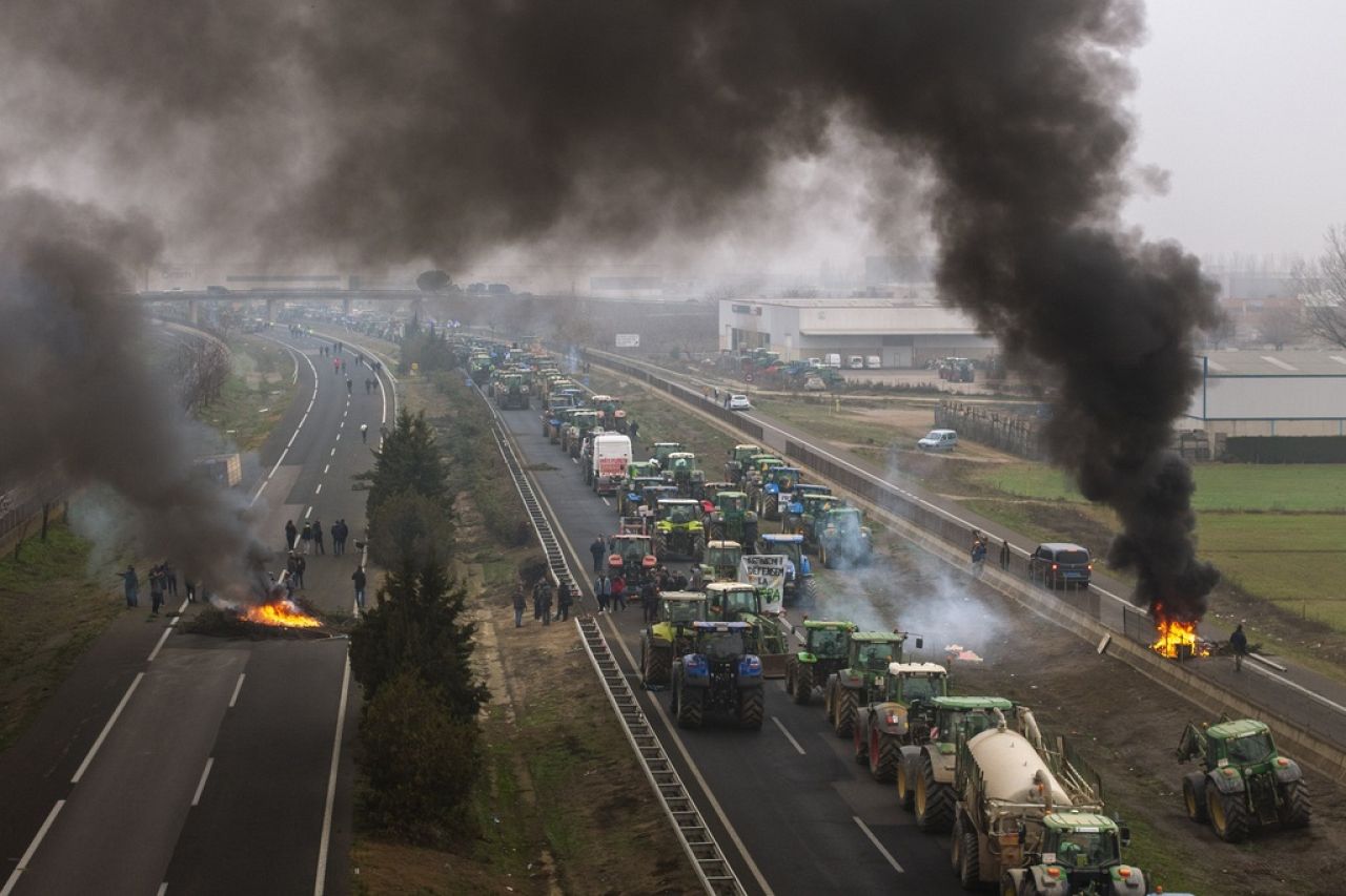 Farmers make barricades after blocking a highway during a protest near Mollerussa, Spain.